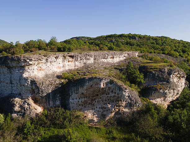 Drone flight over archeological evidence of ancient civilizations in rural region with petroglyphs, ancient rock dwellings & ancient drawings. History concept.