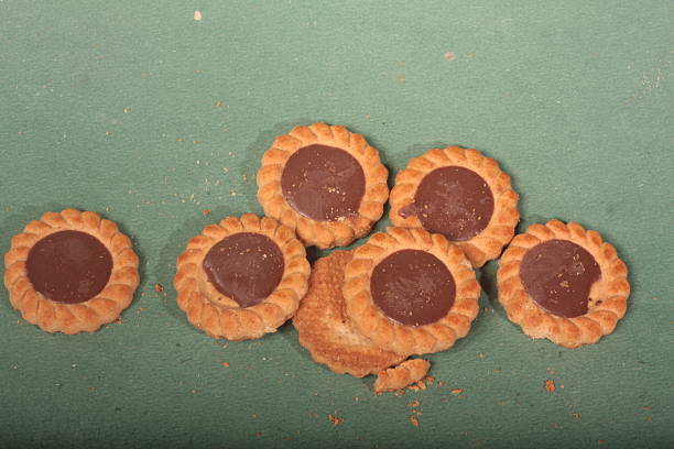A neatly arranged grid of square crackers on a brown background, showcasing their golden-brown color, simplicity, and potential as snacks for any occasion or gathering.