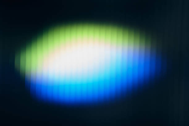 Abstract glowing light creating a vibrant green, white, and blue gradient pattern on a dark background