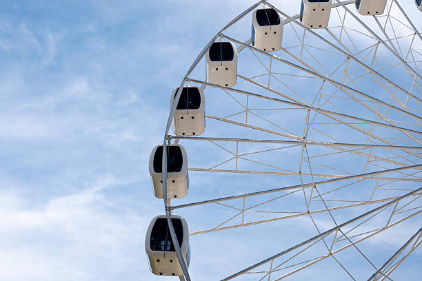 Magdeburg, Germany - 12/10/2022: Ferris wheel at night with lots of lights and a dark black sky in the background