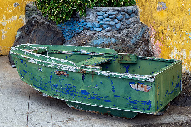 Old wooden weathered boat drying out in the sun.