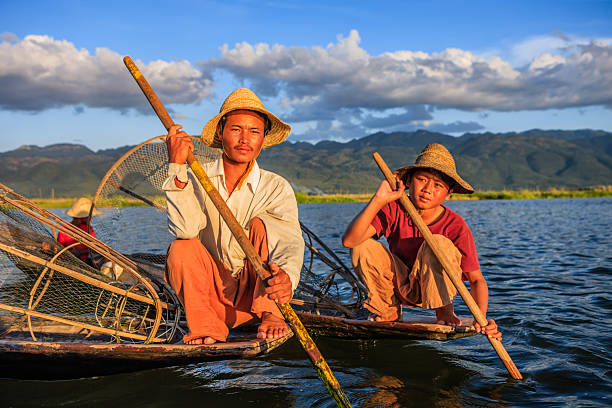 Fisherman posing on Inle Lake. Leg-rowing fishermen on Inle Lake are a major tourist destination in Myanmar (Burma).