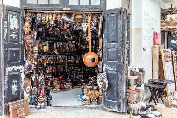 Stone Town, Zanzibar, Tanzania - February 8, 2026: The street store with a lot of traditional african masks and figurines at old fort craft market