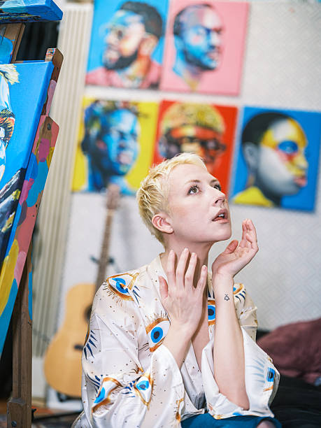 Young blonde woman posing for her portrait. Interior of artist studio in Toronto, Canada.