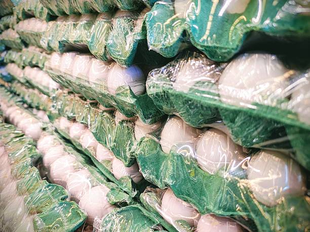 Stacked white egg cartons in a market