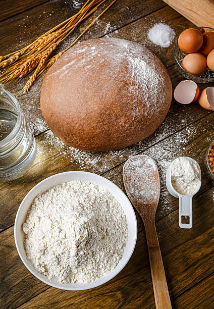 Low key image of artisanal Sourdough Bread making, ingredients and utensils
