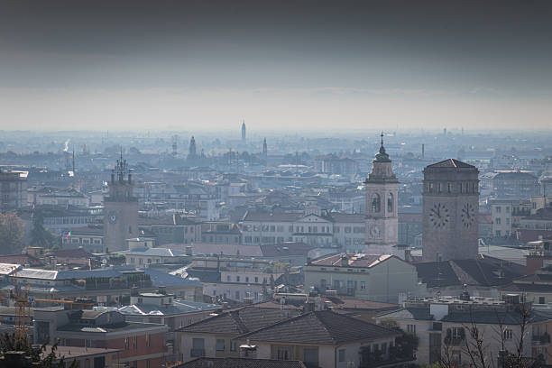 Italian Bergamo cityscape with multiple clock towers and dense terracotta rooftops
