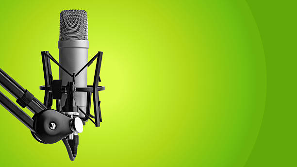 Close up of a podcast microphone on a stand with green star shapes