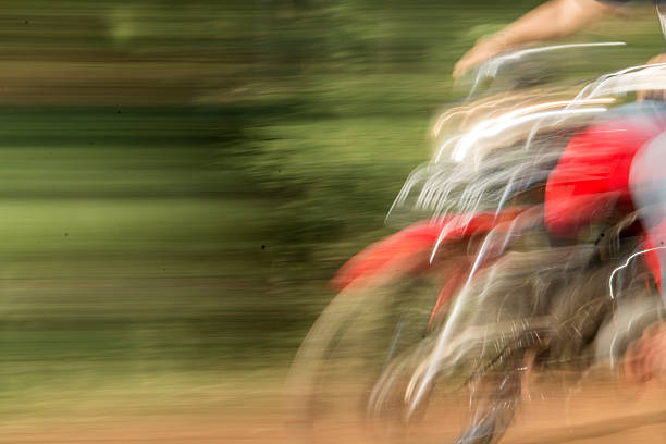 Abstract motion blur of a motorcycle riding fast on countryside road. Concept of speed, freedom, adventure, transportation, dynamic energy, outdoor lifestyle, rural mobility.