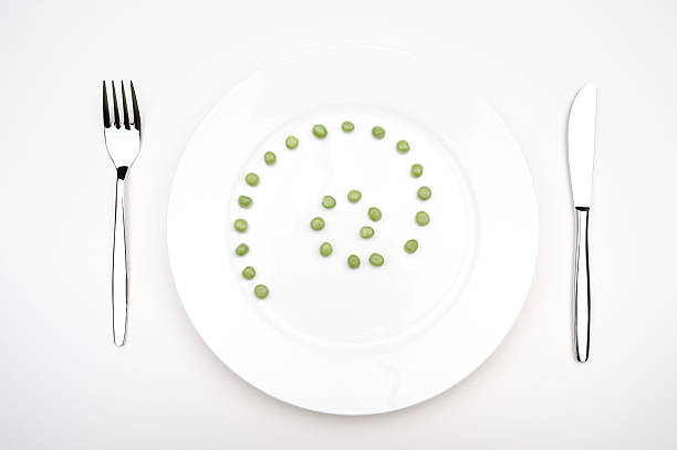 Green vegetables, peas, corn and asparagus, served on two gray plates on wooden rustic table. food background, copy space, flatlay, Healthy food concept