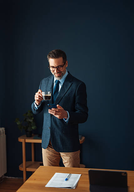 Businessman Enjoying Coffee While Using Phone