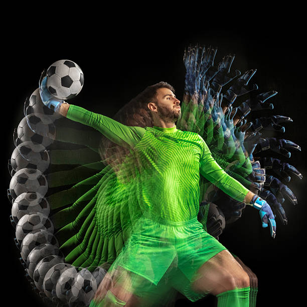 a pair of goalkeeper gloves rest symmetrically on the edge of the goal