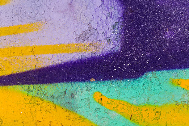 istock Colorful graffiti elements on a weathered wall with bold purple, teal, and yellow lines 2262624403