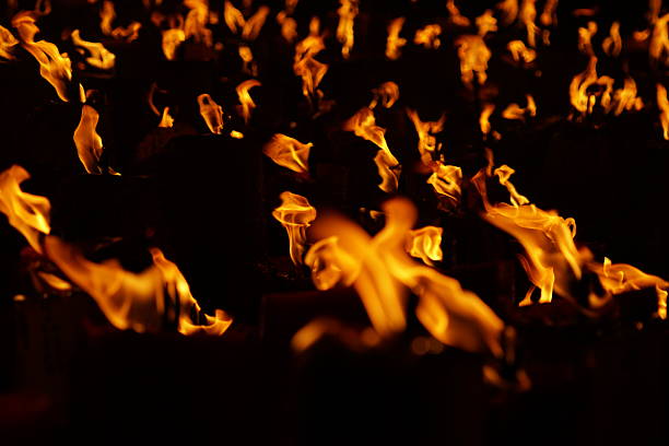 Goias, Goias, Brazil – April 06, 2023: Several faithful holding fire torches during the Procession of Fogaréu, a religious festival that takes place in the city of Goiás.