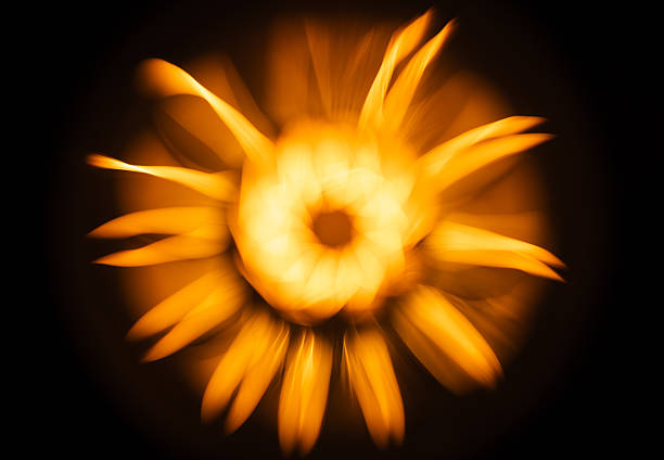An abstract flower pattern of a blurred tungsten lamp glowing in the dark,  blurred photo background
