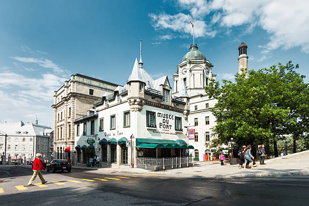 Pedestrians walk in downtown Quebec City, Canada, on a sunny day.