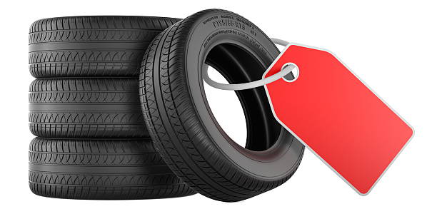 Winter tires with alloy wheel lying on snow against white background