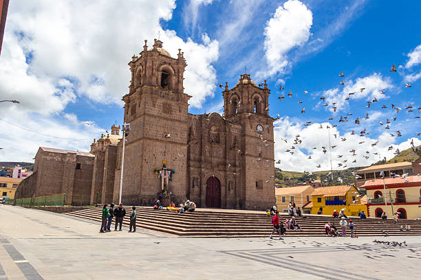 Puno District, Puno Region, Peru - February 18, 2026: Pigeons flying and Cathedral at Puno Main Square