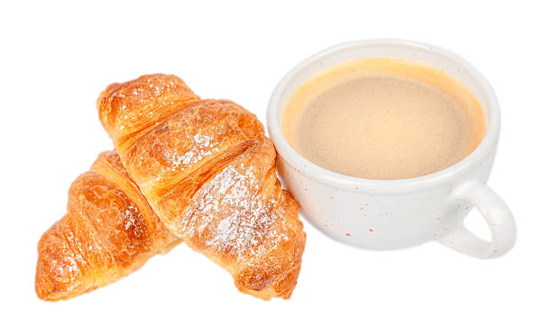 istock Two powdered croissants with cappuccino in white cup 2262706620