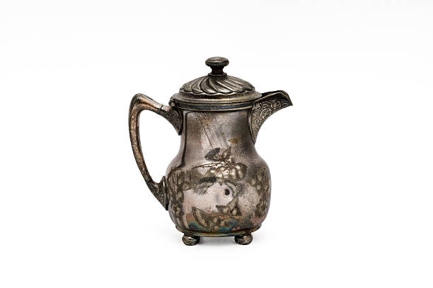 Detailed capture of a vintage silver object placed on a table, photographed in Mallorca, Spain, depicting beautiful craftsmanship amidst a natural and serene environment.