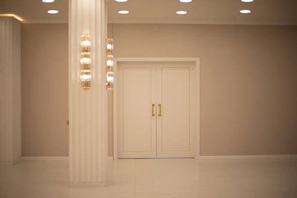 Doors in the interior. Warm light in the hall. Closed doors. Room for a celebration.