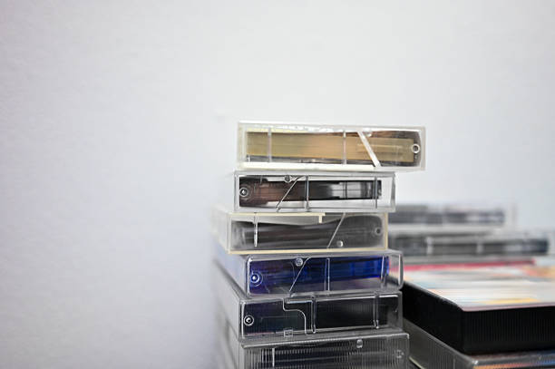 Stacked cassette tapes with clear plastic cases representing retro audio media