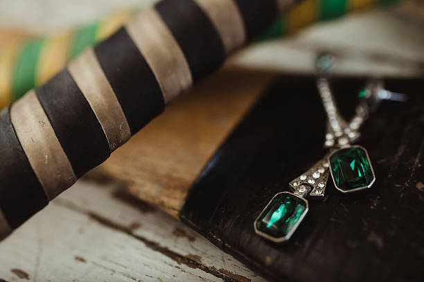 Fashion emerald and diamond dangle earrings with hockey sticks in background