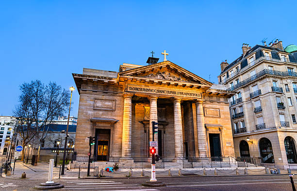 Church of Saint-Philippe-du-Roule stands in the 8th district of Paris, France. Neoclassical architecture features the stone facade with columns and pediment illuminated by sunset light