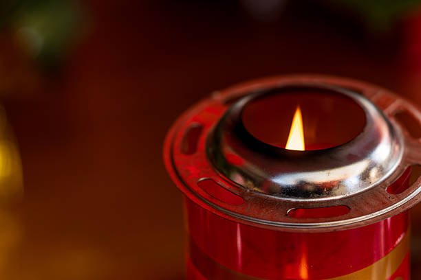 flame and burning wick on an oil torch against an overcast sky