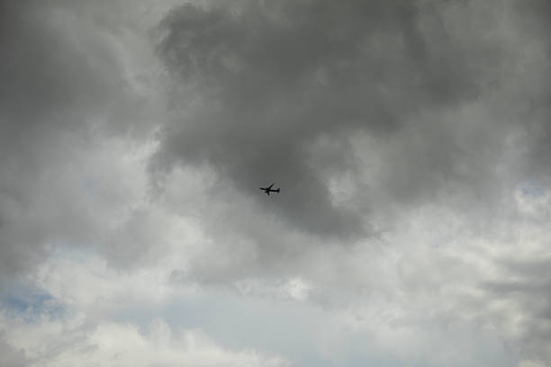An airplane in the sky. An airplane against gray clouds. Details of the flight.