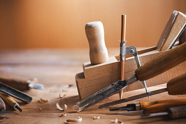 Woodworking tools on wooden workbench in carpentry workshop. Joinery and craft carving tools set for wood processing.
