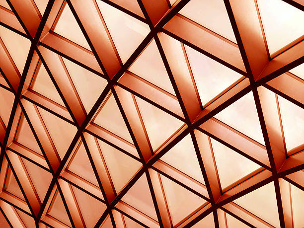Glass canopy showcasing repeating geometric frames and day light.