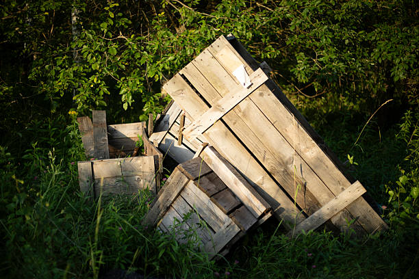 High angle view of abandoned wooden planks and drawers lying over wall in the street
