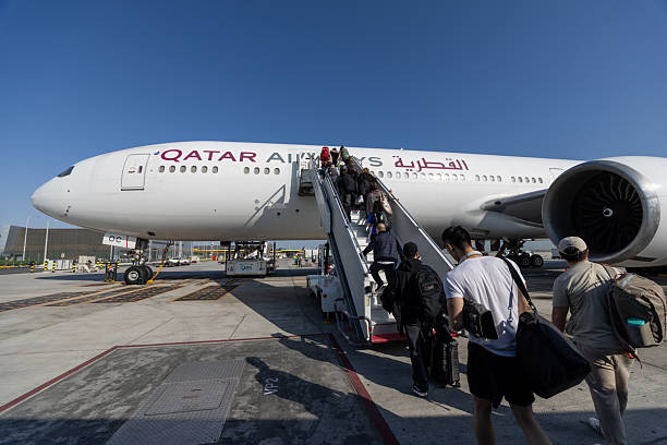 Doha, Qatar - February 15, 2026 : Passengers board a Qatar Airways Boeing 777-300ER at Hamad International Airport in Doha, Qatar.