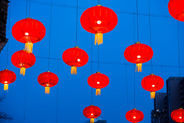 Red chinese langterns in early night sky at night market in Bangkok at Phahoyothin Road