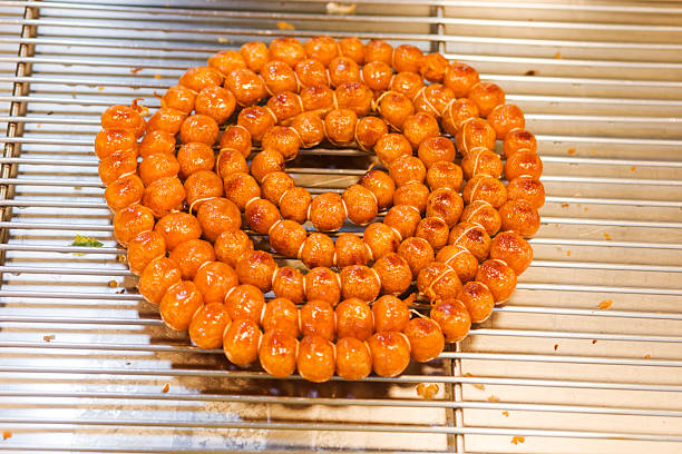 Grilled thai pork sausages ring on night market in Bangkok at Phahonyothin Road