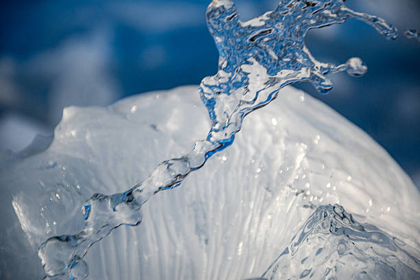 abstract photography with water splashes on a frozen ice container, blue and white tone, cold winter day