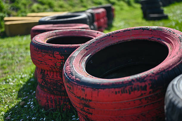 Row of red painted tires functioning as a safety barrier on a kart track
