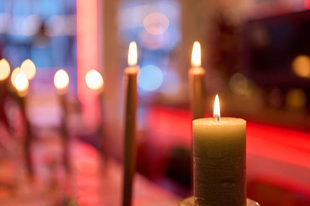 Candles burning on a table, creating warm light and a festive atmosphere