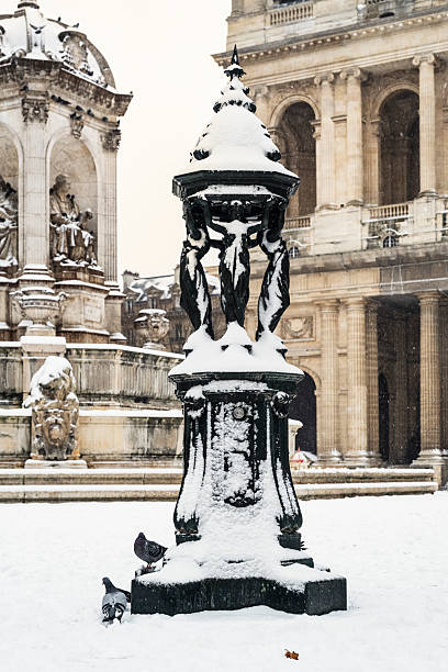 Paris: snow-covered Wallace fountain, Place Saint-Sulpice