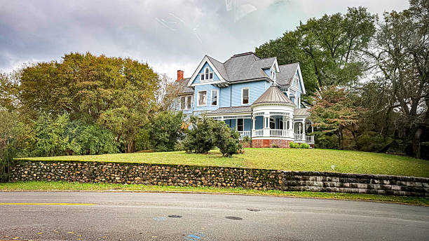 On October 21st 2025 in Chattanooga, Tennessee this is a Queen Anne style house. This style is known for its whimsical, richly detailed design, often featuring a mix of textures and shapes. Common elements include wraparound porches, steep rooflines, and asymmetrical facades.Historical Context: Many of these iconic homes were built in the late 19th century.