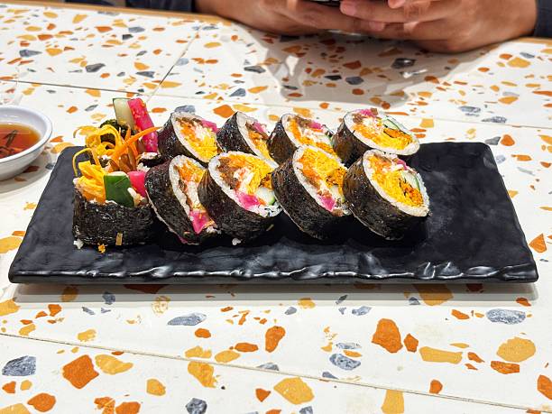 Enjoy the deliciousness of authentic Korean Kimbap filled with fresh vegetables and rich egg