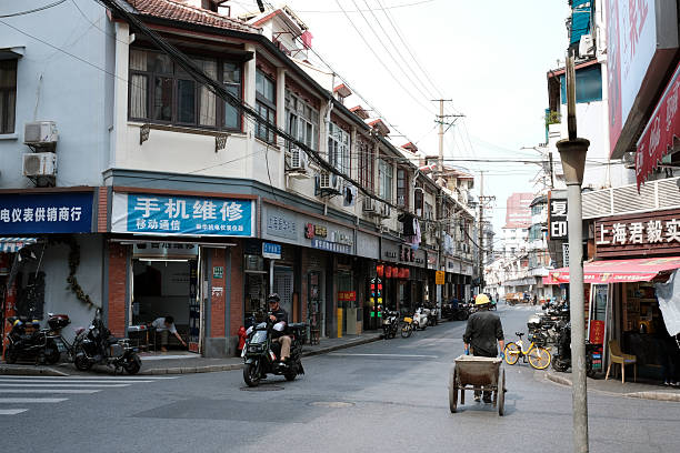 People on the street surrounded by old fashioned residential buildings in Huangpu district, Shanghai, China.