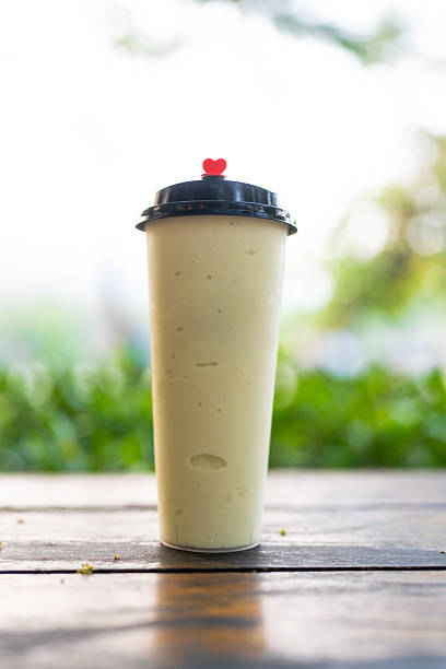 Creamy avocado smoothie poured into a clear cup
