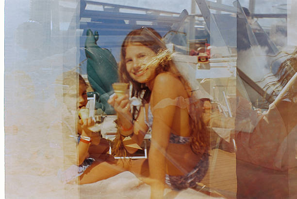 Two girls enjoying ice cream on a beach, double exposure effect creating a layered, nostalgic summer scene