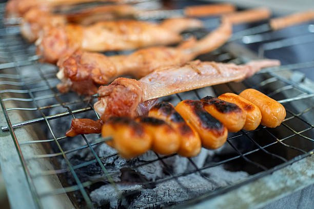 Grilled Sausages and Chicken Wings on Charcoal Barbecue Grill