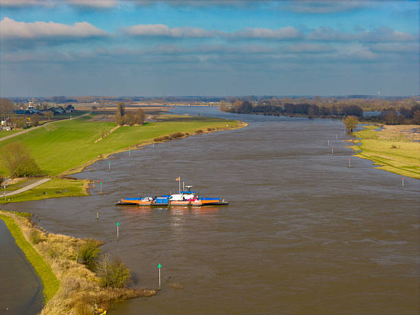Ferrysailing on the IJssel river with high water level on the floodplains of the river IJssel at Wijhe in February 2026.