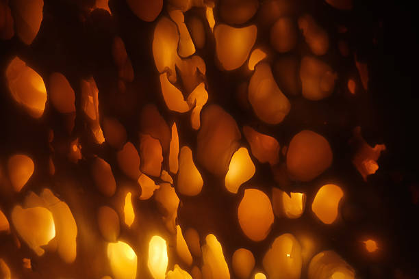 Warm abstract glowing orange organic holes resembling molten lava or backlit stone, soft depth, atmospheric bokeh lighting