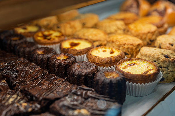 Assorted Brownies and Portuguese Egg Tarts on Bakery Display