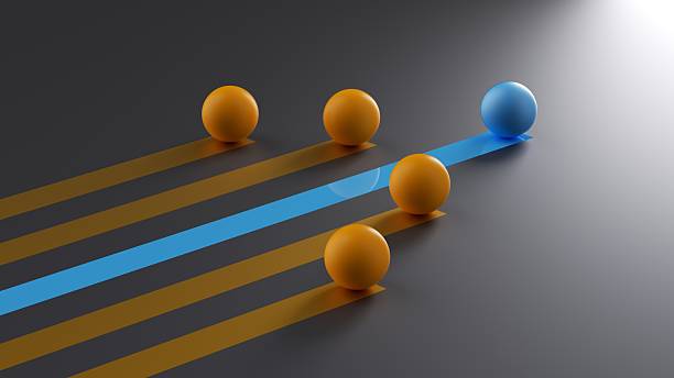 This dynamic three-dimensional illustration depicts a blue sphere speeding ahead of a group of orange spheres on parallel tracks. The sleek design symbolizes leadership, competitive advantage, and staying ahead of the curve in a fast-paced business market. The visual metaphor effectively communicates concepts of progress, winning, and high performance. Ideal for corporate strategy documents, financial reports, and marketing campaigns that emphasize speed, efficiency, and the drive to achieve goals. The dark background adds a modern, tech-forward aesthetic suitable for innovation and technology themes.